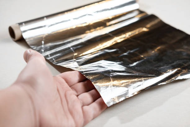 istock cooking foil in hand closeup 1067751120