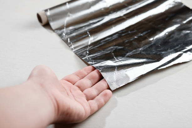istock cooking foil in hand closeup 1067751360