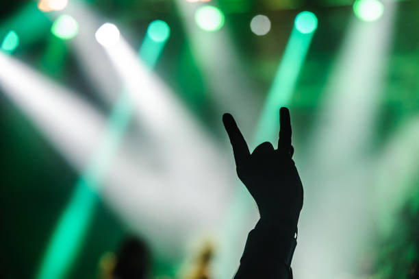 istock Hands raised showing a heavy metal rock sign, devil horns 1067753044