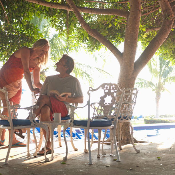 Couple read books and relax under trees