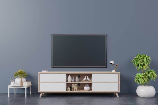 istock TV on wall with cabinet in modern empty room 1067756314
