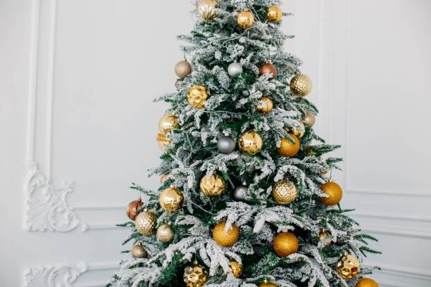 istock Christmas gifts under the tree. Yellow decorative balls. 1067762986