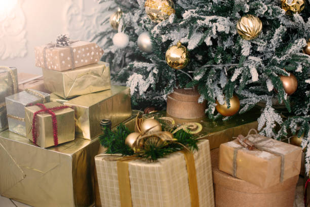 istock Christmas gifts under the tree. Yellow decorative balls. 1067764290