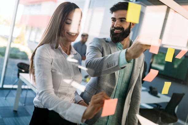 istock Business people discussing over documents in office lobby. 1067767014