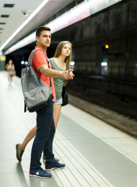 istock Couple is standing on platform and waiting train 1067767248
