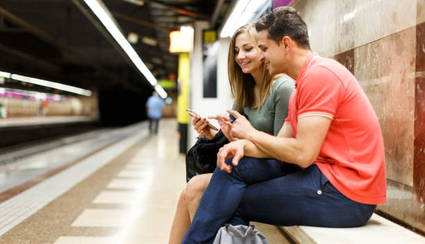 istock Couple is waiting train on the bench and looking on map 1067767270