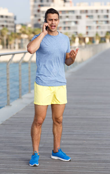 istock Athletic man talking by phone 1067769858