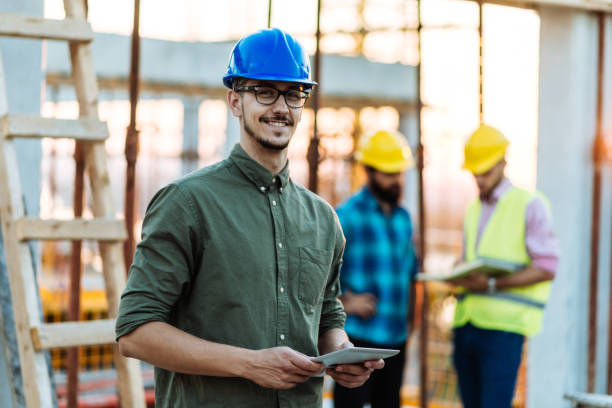 istock Portrait of group of engineers and architects on construction site 1067770800