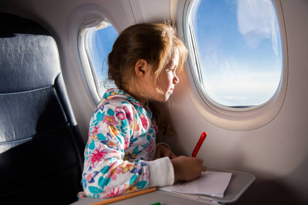 istock Child drawing picture with crayons in airplane. 1067772850