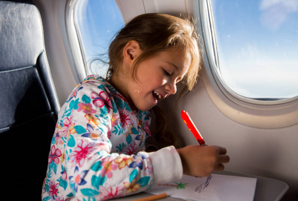 istock Child drawing picture with crayons in airplane. 1067772852