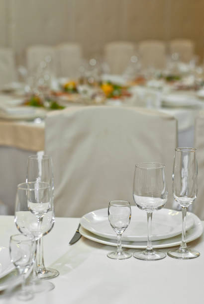 istock Glass dishes on a table on a white tablecloth. clean and empty. lovely, chic restaurant. cozy atmosphere. serving a banquet 1067773054