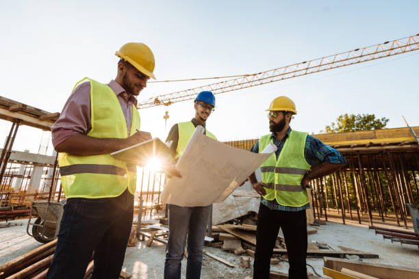 istock Photo of large scale construction site with engineers and blueprint 1067774586