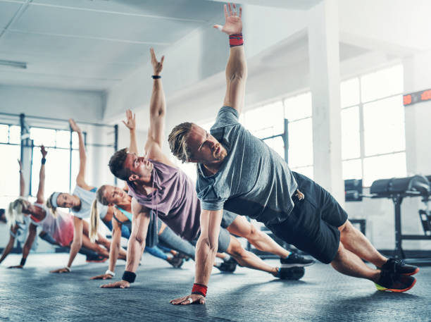 It all starts with determination! Shot of an accountability group working out at the gym bodyweight training photos stock pictures, royalty-free photos & images