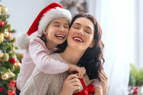 istock mom and daughter exchanging gifts 1067775358