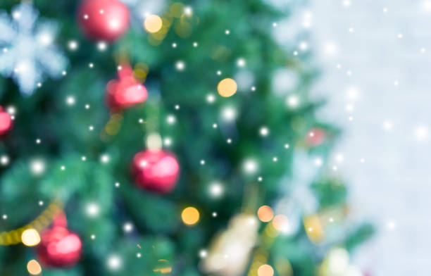 istock abstract blurred beautiful tree with ornate decoration inside sweet house background with snowfall effect for merry christmas and happy new year ; montage image or ads and banner design element 1067777448