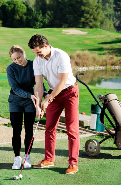 istock Woman golfer training man to play golf 1067780814