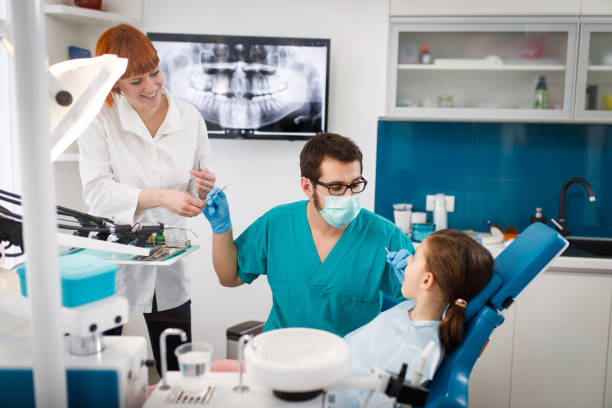 istock Little girl at dentist's office having routine checkup 1067782044