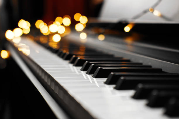 istock piano keys bokeh in the background Christmas lights 1067782710