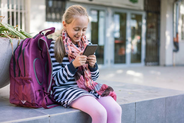 istock Blond girl browsing on her phone while waiting outside a building 1067782848