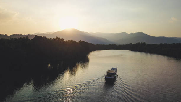istock Riverboat sailing towards Sunset, Cambodia 1067783034