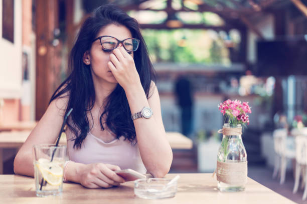 istock Young depressed woman having a drink at the bar 1067787788