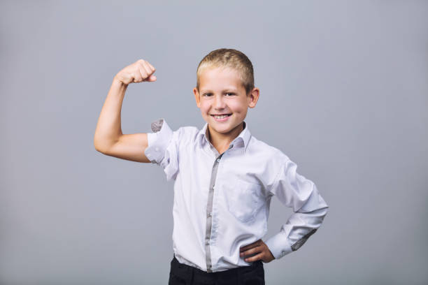 istock Boy in school uniform fashionable beautiful and confident in Studio on grey background 1067789726