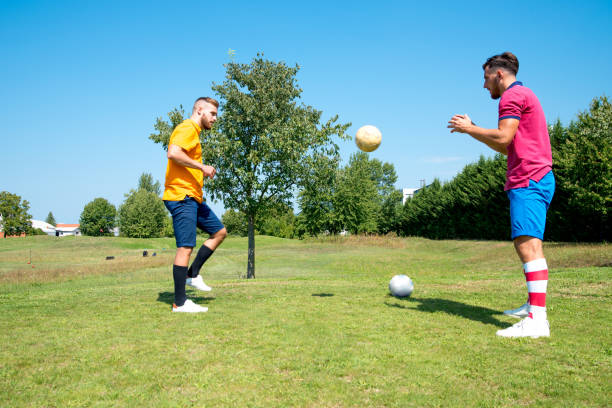 istock Two Male Footgolf Players Juggling On Course 1067793148