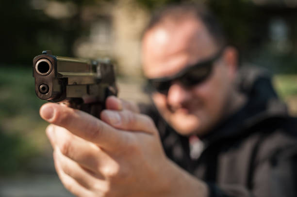 istock Police agent bodyguard gun pointing pistol to attacker. Front view 1067798154
