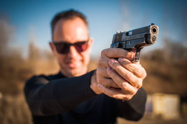 istock Police agent bodyguard gun pointing pistol to attacker. Front view 1067799296