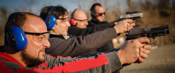 istock Group of people practice gun shooting on outdoor shooting range 1067799464