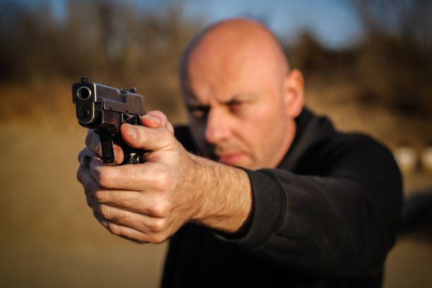 istock Police agent bodyguard gun pointing pistol to attacker. Front view 1067799652