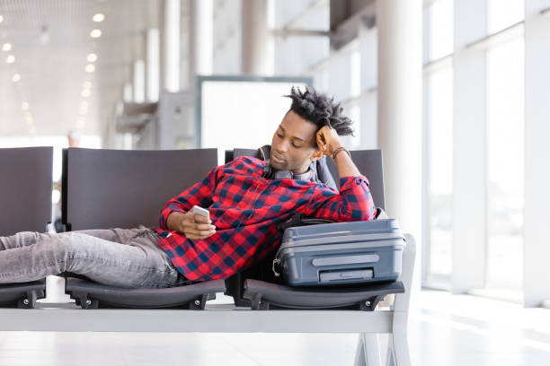 istock Young man waiting for flight in airport lounge 1067802722