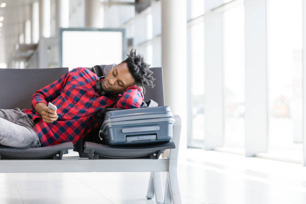 istock Young man waiting for flight in airport lounge 1067802936