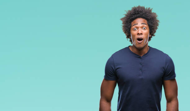 istock Afro american man over isolated background afraid and shocked with surprise expression, fear and excited face. 1067803258