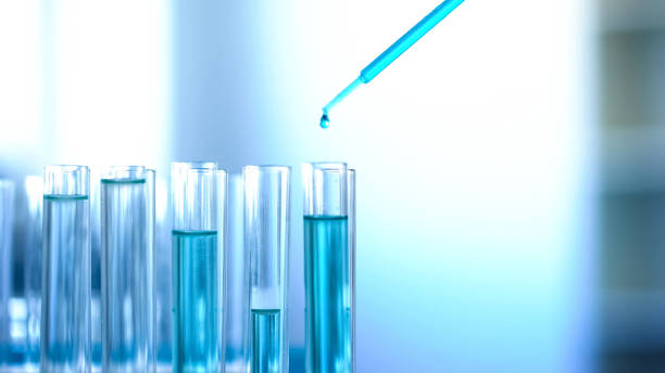 istock Blue chemical liquid dripping in lab tubes, cleaning agent testing experiment 1067805766