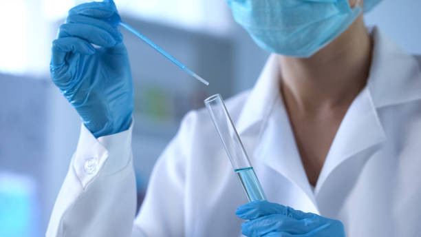 istock Chemistry scientist pouring blue liquid in lab tube, new detergents development 1067806318