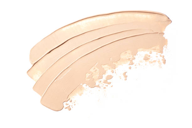 bright beige smear of foundation in the form of a group of diagonal strokes isolated on a white background. - make up brush imagens e fotografias de stock