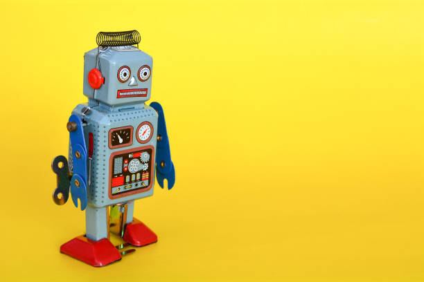 istock Vintage tin toy robot isolated on a yellow background. 1067806336