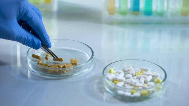 istock Lab technician taking pill from petri dish with lancet, pharmaceutical industry 1067807216