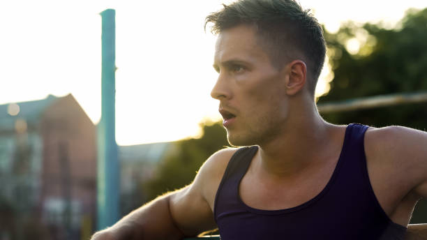 istock Handsome Caucasian sportsman relaxing after hard workout on parallel bars 1067808806