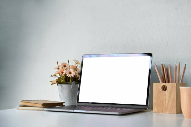 istock Blank screen laptop with home office supplies on desk. 1067809420