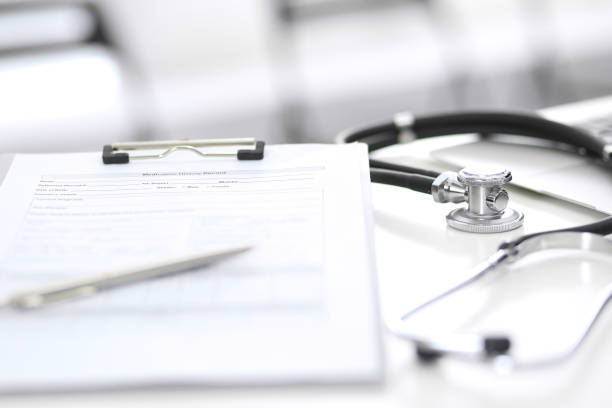 istock Stethoscope, clipboard with medical form lying on hospital reception desk with laptop computer. Medical tools at doctor working table.Medicine aÑÐ² health care concept. 1067812154