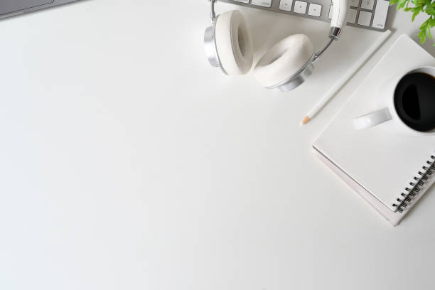 istock White wooden table with laptop and office supplies. workspace and copy space. 1067813524