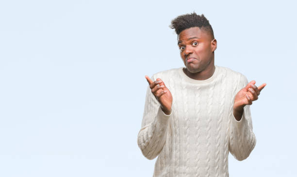 istock Young african american man over isolated background clueless and confused expression with arms and hands raised. Doubt concept. 1067814012