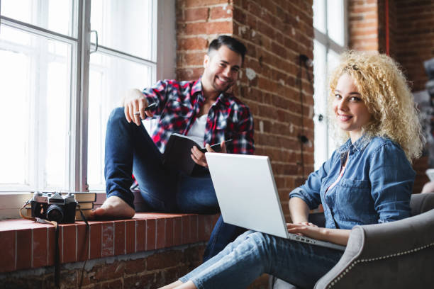 istock Couple in modern loft interior with a laptop. 1067816748