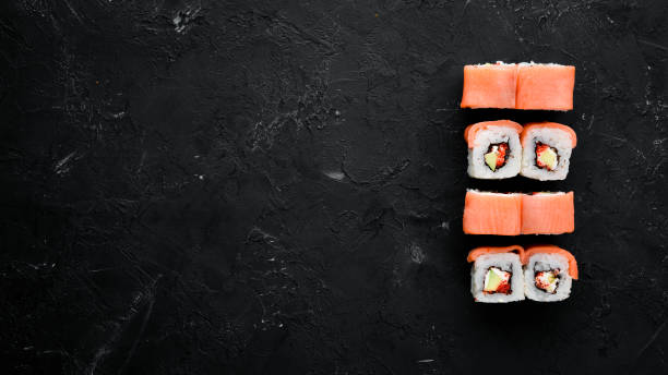 istock Sushi roll with seafood. Top view. On a white wooden background. 1067821654