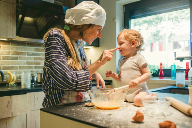 istock playful mother and her son baking together 1067824806