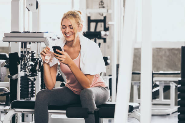 istock Attractive young woman taking a break after exercise at the gym 1067825906
