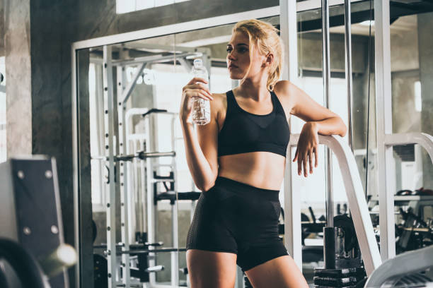istock Attractive young woman taking a break after exercise at the gym 1067825942