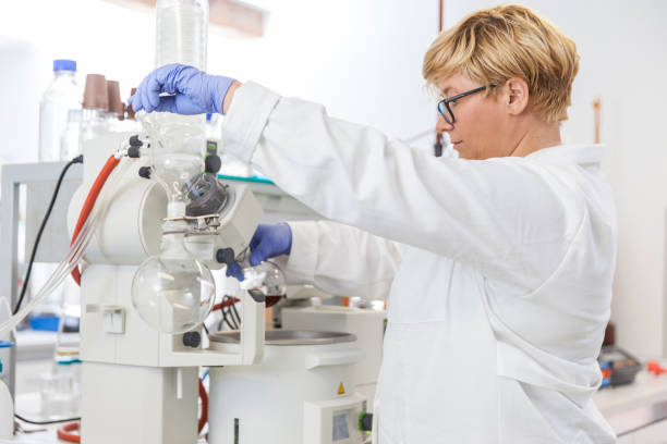 istock Female Researcher Using Machine For Alcohol Evaporation from Wine in Vacuum Chamber 1067828818
